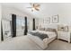 Bright main bedroom with large windows, a ceiling fan, and a neutral color palette at 10252 E Butherus Dr, Scottsdale, AZ 85255