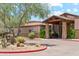 Inviting entrance of a local restaurant with stone accents, outdoor seating, and desert landscaping at 10252 E Butherus Dr, Scottsdale, AZ 85255