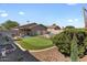 Spacious backyard featuring a putting green, lush landscaping, and a cozy patio area at 1057 E Silversmith Trl, San Tan Valley, AZ 85143