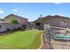 Beautiful backyard features a manicured lawn, patio, and garden at 1057 E Silversmith Trl, San Tan Valley, AZ 85143