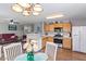 Open kitchen and dining area with stainless steel appliances, island, and a view to the living room at 1057 E Silversmith Trl, San Tan Valley, AZ 85143