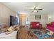 Cozy living room with a ceiling fan, warm colors and comfortable couches at 1057 E Silversmith Trl, San Tan Valley, AZ 85143