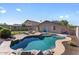 Backyard view showcasing a uniquely shaped private in-ground pool and patio at 1057 E Silversmith Trl, San Tan Valley, AZ 85143