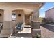 Inviting covered front porch with seating area and decorative accents on the home's exterior at 1057 E Silversmith Trl, San Tan Valley, AZ 85143