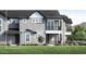 A view of the beautiful two-story home featuring a gray exterior, large windows, and a well-manicured lawn at 11300 N Casa Dega Dr # 1082, Surprise, AZ 85388