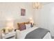 Cozy bedroom with a patterned accent wall, complemented by decorative lighting and soft textiles for a soothing retreat at 12438 E Verbina Ln, Florence, AZ 85132