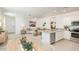 Bright and airy living room, seamlessly connected to the modern kitchen, offers an open concept design for flexible living at 12438 E Verbina Ln, Florence, AZ 85132