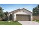 Inviting single-story home with a two-car garage and a neatly landscaped front yard at 12469 E Verbina Ln, Florence, AZ 85132