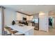 Modern kitchen featuring white cabinetry, stainless appliances, and a breakfast bar with seating at 12469 E Verbina Ln, Florence, AZ 85132