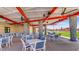 Outdoor seating area with tables, chairs, and shaded structure, great for community gatherings at 12469 E Verbina Ln, Florence, AZ 85132