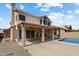 Expansive backyard featuring a covered patio with ceiling fan and a sparkling swimming pool, perfect for outdoor living at 12935 E Mercer Ln, Scottsdale, AZ 85259