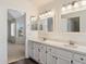 A well-lit bathroom offers dual sinks, ample counter space, and a view into the main bedroom at 12935 E Mercer Ln, Scottsdale, AZ 85259