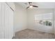 Carpeted bedroom with window view and closet, offering a calm and inviting space at 12935 E Mercer Ln, Scottsdale, AZ 85259