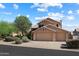 Charming two-story home featuring a three-car garage and a beautifully landscaped front yard at 12935 E Mercer Ln, Scottsdale, AZ 85259