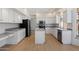 A well-lit kitchen featuring white cabinetry, stainless steel appliances, and a functional center island at 12935 E Mercer Ln, Scottsdale, AZ 85259