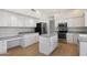 A bright kitchen boasts white cabinets, stainless steel appliances, and a center island for food preparation at 12935 E Mercer Ln, Scottsdale, AZ 85259