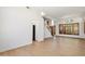 Open-concept living space with light wood floors, staircase and ample natural light at 12935 E Mercer Ln, Scottsdale, AZ 85259