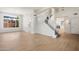 Bright living room featuring wood floors, a staircase, and ample natural light through large windows at 12935 E Mercer Ln, Scottsdale, AZ 85259