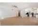 Spacious living room that flows into a modern kitchen, featuring light wood floors and an open layout at 12935 E Mercer Ln, Scottsdale, AZ 85259