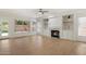 Bright living room with built-in shelving, fireplace, light wood floors and natural light at 12935 E Mercer Ln, Scottsdale, AZ 85259