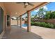 Covered patio with ceiling fan overlooking the backyard, perfect for outdoor relaxation at 12935 E Mercer Ln, Scottsdale, AZ 85259