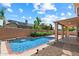 Backyard oasis with a pool, solar panels and a covered patio, perfect for outdoor living at 12935 E Mercer Ln, Scottsdale, AZ 85259