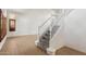 Elegant staircase with white banister and carpeted steps, complemented by light wood flooring at 12935 E Mercer Ln, Scottsdale, AZ 85259