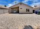 Backyard featuring a covered patio with a rock yard at 13030 W Hearn Rd, El Mirage, AZ 85335