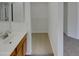 Bright bathroom featuring a sink with wood cabinets and a walk-in closet at 13030 W Hearn Rd, El Mirage, AZ 85335