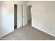 Carpeted bedroom offers closet and an open doorway at 13030 W Hearn Rd, El Mirage, AZ 85335