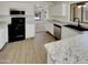 Modern kitchen boasts granite countertops, stainless steel appliances, and an open concept design at 13030 W Hearn Rd, El Mirage, AZ 85335