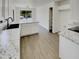 Bright kitchen with white cabinets, granite countertops, stainless steel sink, and wood look floors at 13030 W Hearn Rd, El Mirage, AZ 85335