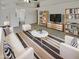 Bright living room with white walls, ceiling fan, a striped rug, and two white couches and chairs at 13030 W Hearn Rd, El Mirage, AZ 85335