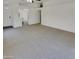 Bright living room with white walls, ceiling fan, and light carpet at 13030 W Hearn Rd, El Mirage, AZ 85335
