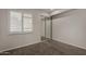 This cozy bedroom has neutral walls, carpet, and natural light from the window at 154 W 5Th St # 210, Tempe, AZ 85281