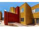 Exterior view of townhome highlighting red and yellow design elements, plus landscaping at 154 W 5Th St # 210, Tempe, AZ 85281