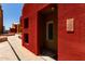 Close-up of unit entrance featuring red facade and modern lighting fixture at 154 W 5Th St # 210, Tempe, AZ 85281