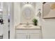 Stylish powder room features a mosaic mirror, stone countertop, and bright lighting at 1600 N Saba St # 214, Chandler, AZ 85225