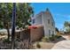 A two-story townhome featuring light blue siding, white trim, privacy walls and mature landscaping at 1600 N Saba St # 214, Chandler, AZ 85225