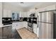 Well-equipped kitchen with stainless steel appliances, white cabinets, and granite countertops at 1600 N Saba St # 214, Chandler, AZ 85225