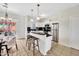 Bright kitchen featuring white cabinets, stainless steel appliances, and breakfast bar seating at 1600 N Saba St # 214, Chandler, AZ 85225
