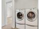 Convenient laundry area featuring white washer and dryer units, offering ease of use at 1600 N Saba St # 214, Chandler, AZ 85225