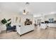 Spacious living room featuring tiled floors, neutral colors, and a cozy fireplace at 1600 N Saba St # 214, Chandler, AZ 85225