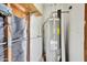 Hot water heater inside utility area with wood and white walls at 1600 N Saba St # 214, Chandler, AZ 85225
