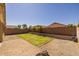 Backyard with green grass turf and rock landscaping at 17038 W Mohave St, Goodyear, AZ 85338