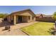 Large backyard with grass turf, low-maintenance rock and brick-paved patio area at 17038 W Mohave St, Goodyear, AZ 85338