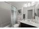 Bright bathroom features a shower-tub combo and a modern single-sink vanity at 17038 W Mohave St, Goodyear, AZ 85338