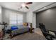 Neutral bedroom with ceiling fan, plush carpet, and a window to the outside at 17038 W Mohave St, Goodyear, AZ 85338