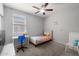 Bright bedroom features a ceiling fan, plush carpet, and neutral paint color at 17038 W Mohave St, Goodyear, AZ 85338