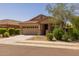 Inviting home with a two-car garage, covered porch, and attractive landscaping at 17038 W Mohave St, Goodyear, AZ 85338